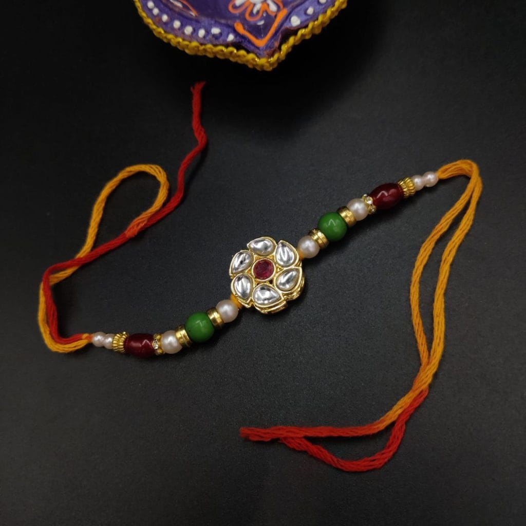 Artistic Kundan Meena Work Rakhi with Floral Motifs