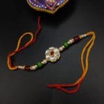 Artistic Kundan Meena Work Rakhi with Floral Motifs