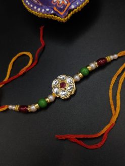 Artistic Kundan Meena Work Rakhi with Floral Motifs
