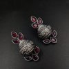 Silver flower pot earrings inspired by Kalash culture, crafted with intricate silver detailing.