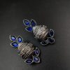 Silver flower pot earrings inspired by Kalash culture, crafted with intricate silver detailing.