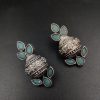 Silver flower pot earrings inspired by Kalash culture, crafted with intricate silver detailing.