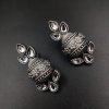 Silver flower pot earrings inspired by Kalash culture, crafted with intricate silver detailing.