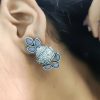 Silver flower pot earrings inspired by Kalash culture, crafted with intricate silver detailing.