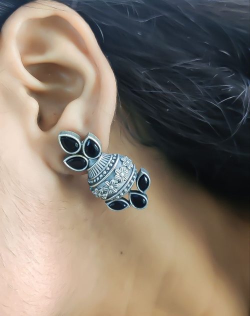 Silver flower pot earrings inspired by Kalash culture, crafted with intricate silver detailing.