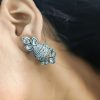 Silver flower pot earrings inspired by Kalash culture, crafted with intricate silver detailing.