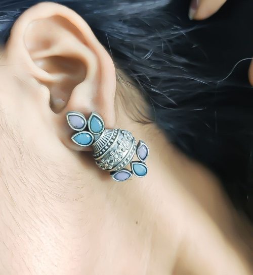 Silver flower pot earrings inspired by Kalash culture, crafted with intricate silver detailing.