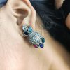 Silver flower pot earrings inspired by Kalash culture, crafted with intricate silver detailing.