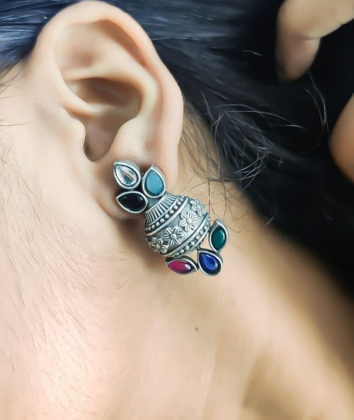 Silver flower pot earrings inspired by Kalash culture, crafted with intricate silver detailing.