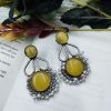 Hand-made silver earrings featuring a stone resembling the Monalisa Stone