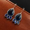 Silver Replica Stone Earrings with oxidized hooks displayed against a textured background