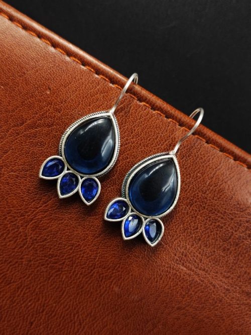 Silver Replica Stone Earrings with oxidized hooks displayed against a textured background