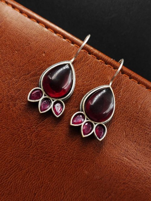 Silver Replica Stone Earrings with oxidized hooks displayed against a textured background