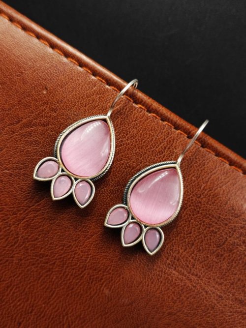 Silver Replica Stone Earrings with oxidized hooks displayed against a textured background