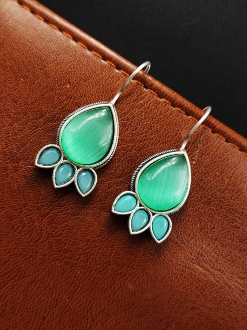 Silver Replica Stone Earrings with oxidized hooks displayed against a textured background