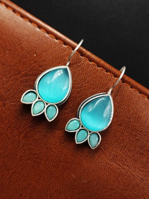 Silver Replica Stone Earrings with oxidized hooks displayed against a textured background