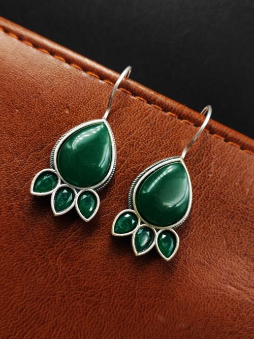 Silver Replica Stone Earrings with oxidized hooks displayed against a textured background