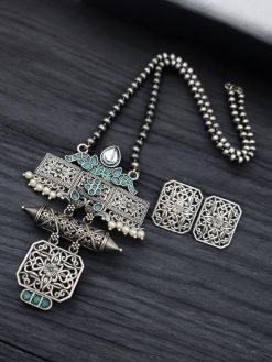 Silver look necklace set with a unique oxidized pendant and matching earrings featuring intricate detailing.