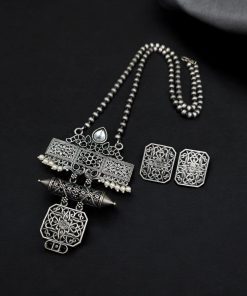 Silver look necklace set with a unique oxidized pendant and matching earrings featuring intricate detailing.