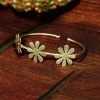 Handmade gold-plated flower design bracelet with adjustable size.