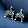 Graceful bird stud earrings in silver replica with intricate stone work, lightweight and elegant.