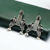 Graceful bird stud earrings in silver replica with intricate stone work, lightweight and elegant.