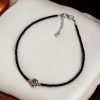 Elegant black beads and flower anklet in silver replica design, adjustable for a perfect fit.