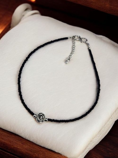 Elegant black beads and flower anklet in silver replica design, adjustable for a perfect fit.