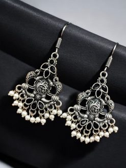 Brass peacock hanging earrings with stone accents, featuring intricate detailing and a vibrant, elegant design