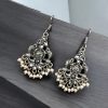 Brass peacock hanging earrings with stone accents, featuring intricate detailing and a vibrant, elegant design