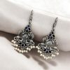 Brass peacock hanging earrings with stone accents, featuring intricate detailing and a vibrant, elegant design