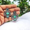 Silver replica earrings with Monalisa stones and a beautiful brass peacock stud design, perfect for elegant and versatile wear