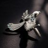 Brass bird ring with sparkling stones, featuring an elegant and intricate design perfect for any occasion.
