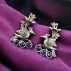 Elegant brass stud earrings featuring intricate bird motifs and sparkling stone details, offering a lightweight and sophisticated design perfect for any occasion.