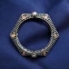 Elegant openable brass stone kada bracelet with intricate stone detailing and adjustable fit. Caption:
