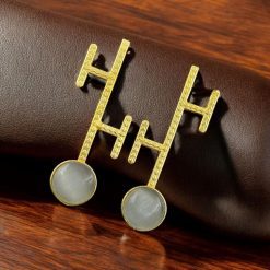 Goldplated Monalisa stone stud earrings with a sleek contemporary design, perfect for modern style lovers.