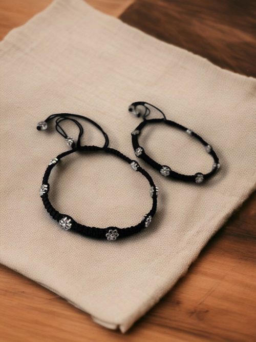 Elegant daily wear anklets with intricate thread work and flower charms in German silver, designed for a graceful and comfortable fit.