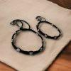 Elegant daily wear anklets with intricate thread work and flower charms in German silver, designed for a graceful and comfortable fit.