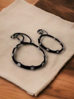 Elegant daily wear anklets with intricate thread work and flower charms in German silver, designed for a graceful and comfortable fit.