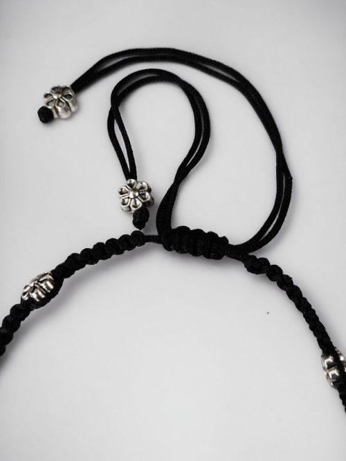Elegant daily wear anklets with intricate thread work and flower charms in German silver, designed for a graceful and comfortable fit.