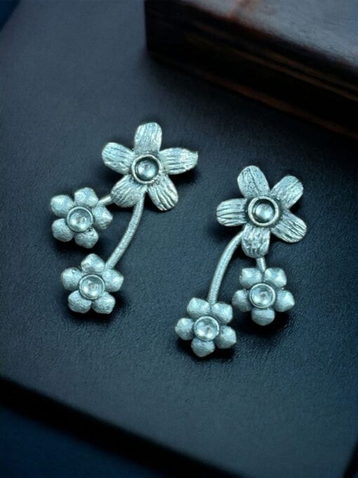 Elegant flower stone stud brass earrings with a delicate floral design and shimmering stones, perfect for adding sophistication to any outfit.