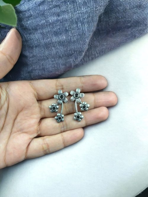 Elegant flower stone stud brass earrings with a delicate floral design and shimmering stones, perfect for adding sophistication to any outfit.