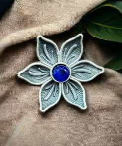 An elegant adjustable brass ring featuring a delicate flower motif with a sparkling stone detail, perfect for any occasion