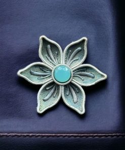 An elegant adjustable brass ring featuring a delicate flower motif with a sparkling stone detail, perfect for any occasion