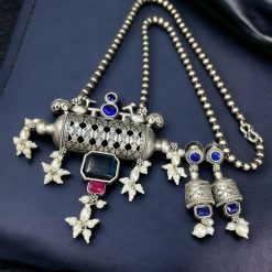 An elegant ethnic brass necklace featuring a bird motif and Monalisa stone, paired with matching earrings for a complete, sophisticated look