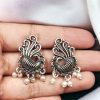 Elegant brass peacock stud earrings with intricate design, perfect for special occasions or daily wear