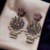 Elegant ethnic hanging bird-styled German silver stone stud earrings with intricate detailing, perfect for any occasion.