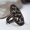 Elegant adjustable brass stone ring with round shape, offering a perfect fit for any finger.