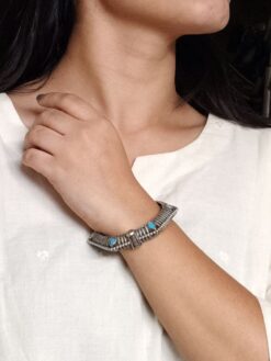 Elegant openable brass stone kada bracelet with intricate stone detailing and adjustable fit. Caption: