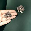 Beautiful German silver peacock stud earrings with intricate detailing and stone embellishments, perfect for adding an ethnic touch to any outfit.